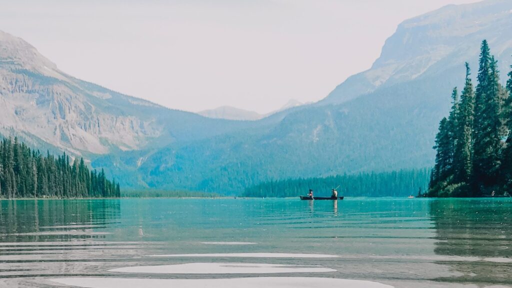 A canoe paddling on Emerald Lake in Yoho National Park. Image credit: Jessica Sproat