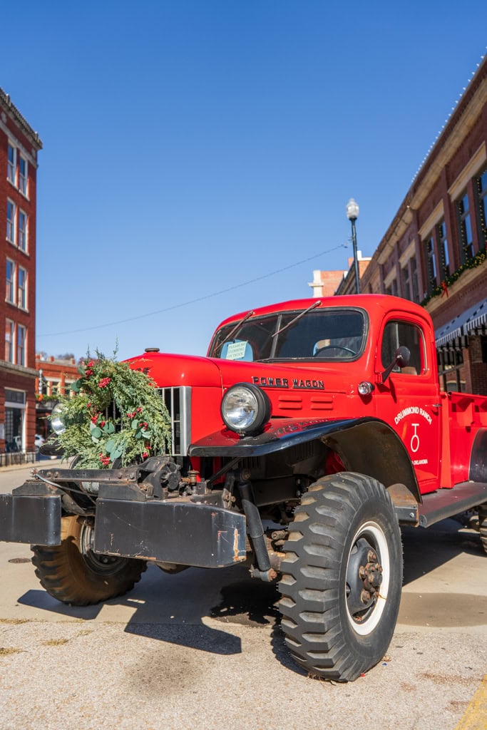 Pawhuska Christmas Towns in Oklahoma Pioneer Woman Mercantile Drummond Red Truck with Christmas Wreath on the Front