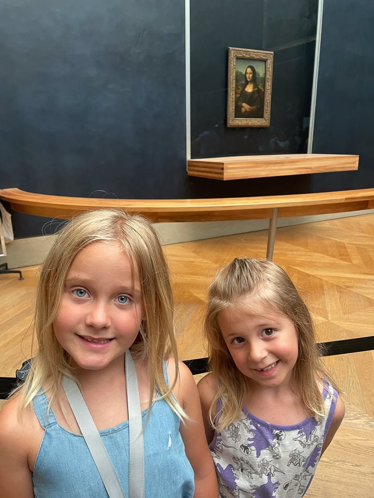 3-Days-In-Paris-On-A-Budget-Louvre-Museum 2 girls smiling with the Mona Lisa in the background