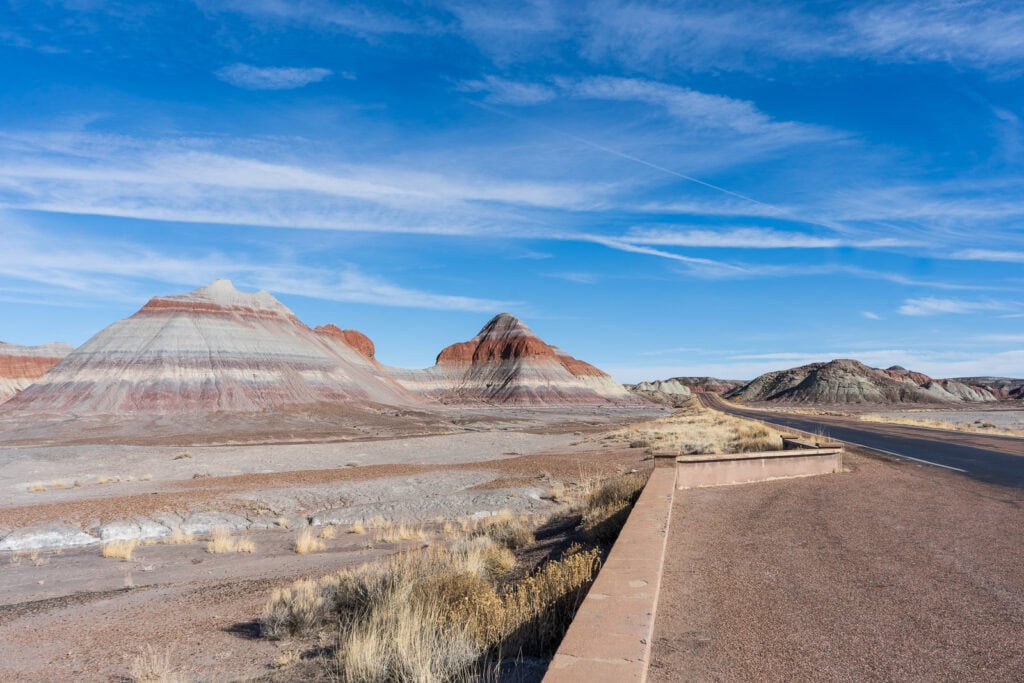 The Tepees in Petrified Forest National Park with horizontal colors of gray, orange, purple, and brown.