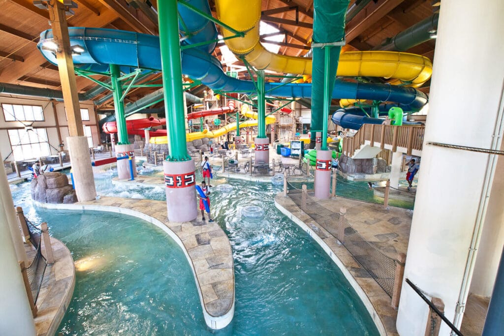 View of the indoor water park at Great Wolf Lodge in Kansas City including the slides, lazy river, and lifeguards on duty.