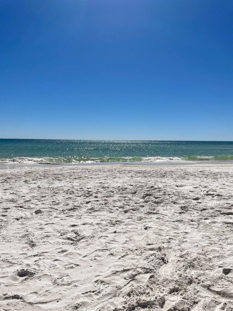 Looking over the white sand meeting the turquoise waters in Destin, Florida.