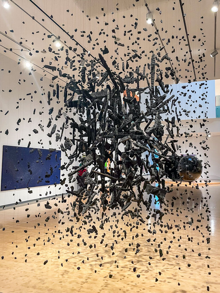 Art installation with hanging black rock pieces at the Phoenix Museum of Art, one of the many things to do in Phoenix, Arizona with kids.